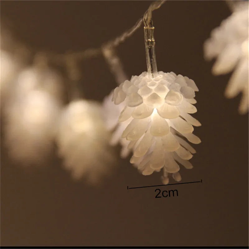 Warm white LED pine cone string lights with plastic shells in battery-powered decorative lighting