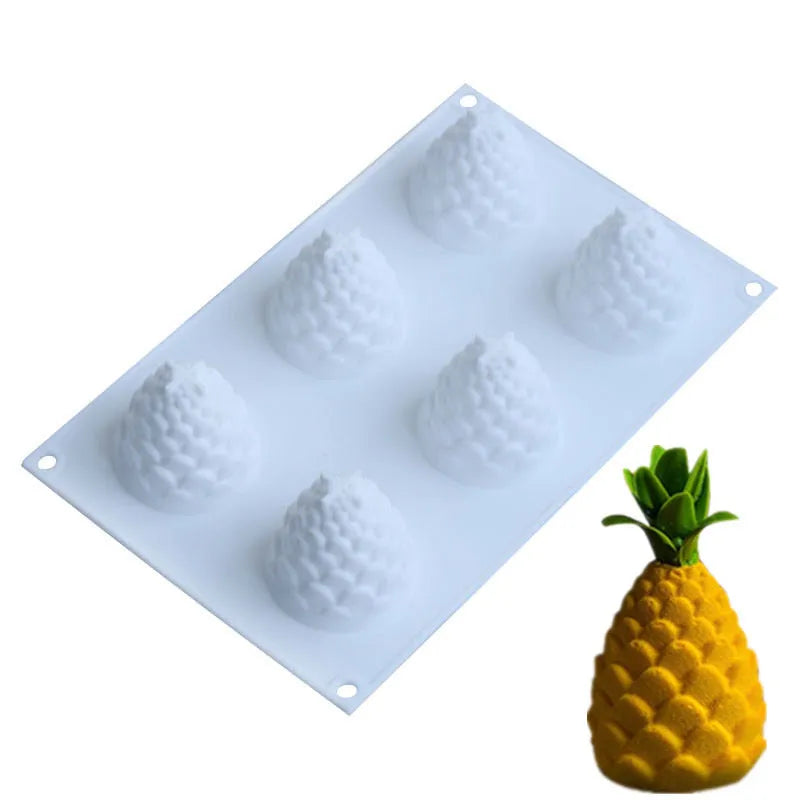 Set of six flexible silicone baking moulds shaped like pears, pineapples, and pine cones.