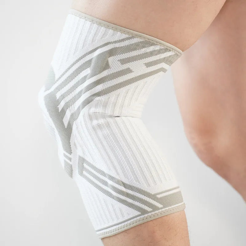 A blue elastic cotton knee pad for adult sports protection, shown alongside grey and yellow colour options.