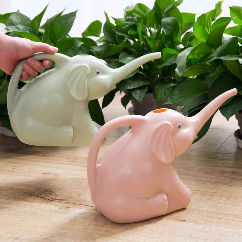 Pink children's watering can shaped like a sitting baby elephant with a long spout.
