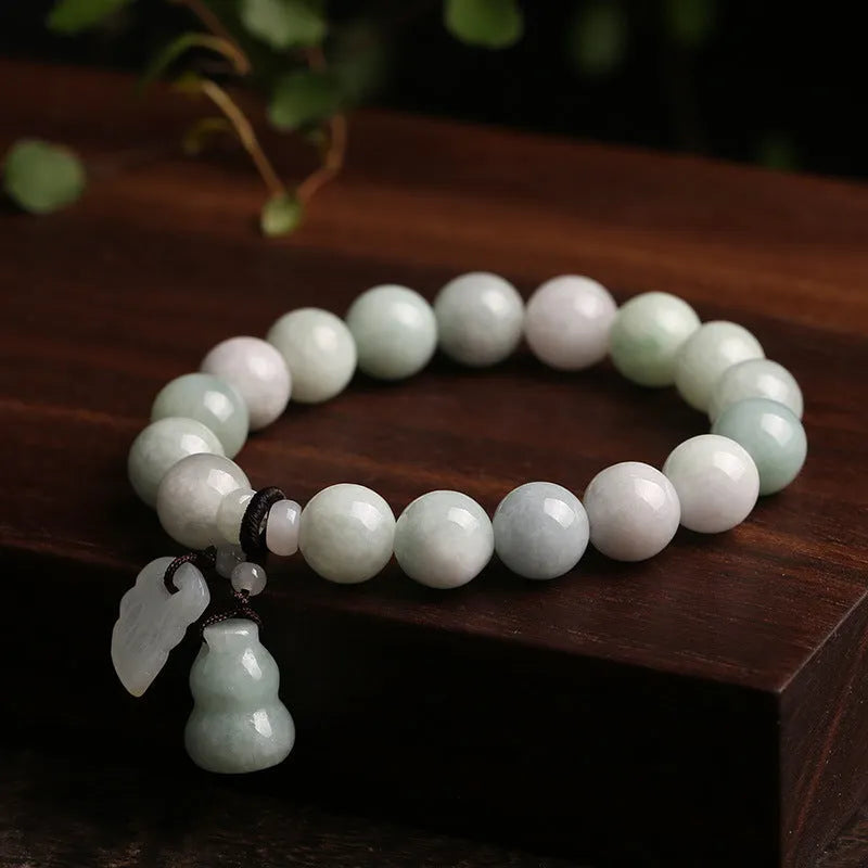 Jade hanging bracelet with Maitreya Buddha, apple, gourd, and money bag charms