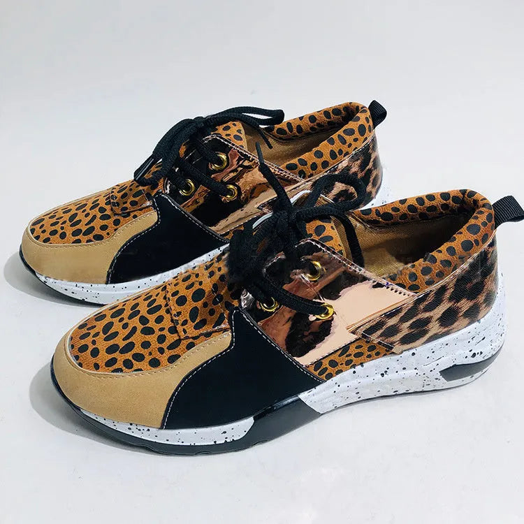 Women's suede flat sneakers with a wedge heel in leopard print, shown from the side.