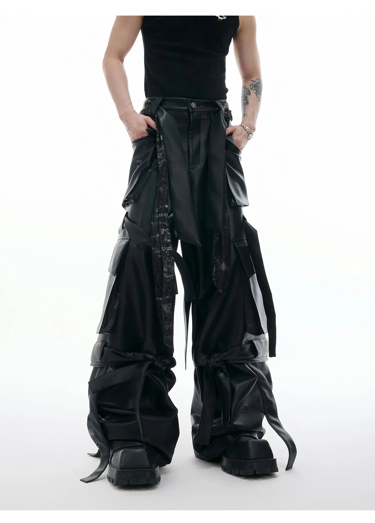 Black retro-style loose-fit trousers with multiple pockets, heavy stitching, and ribbon detail on a hanger.
