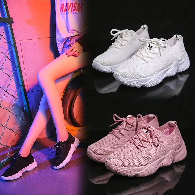 Women's white casual sports shoes with woven upper, thick rubber sole, and front strap fastening
