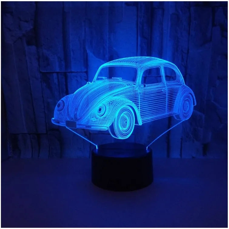 Small 3D LED table lamp with colourful acrylic shade and black ABS base, showing remote control operation