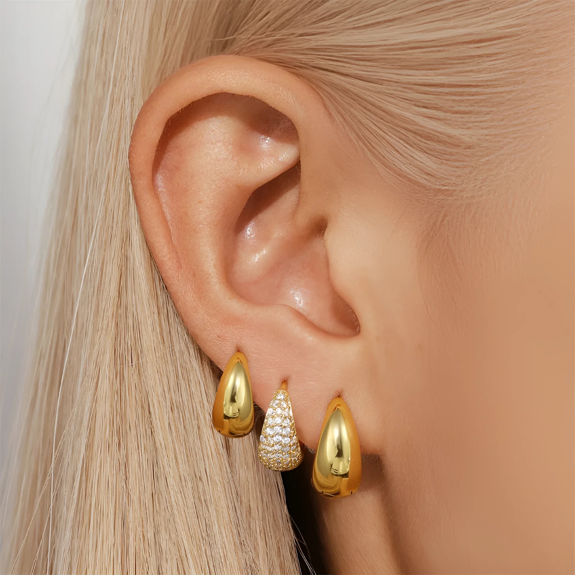 Brass geometric earclip earrings with gold electroplated finish and round design elements