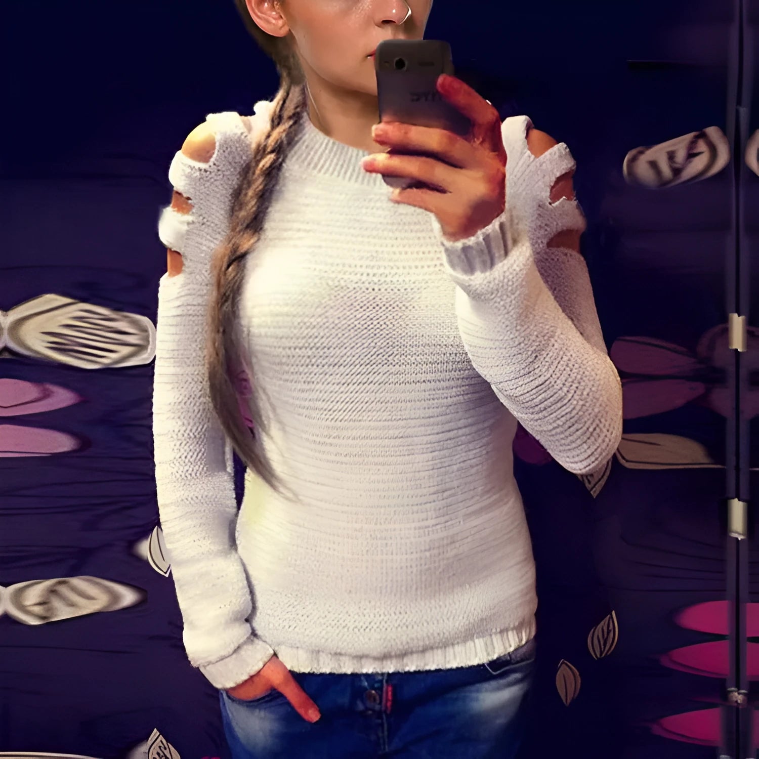 Women's white hollow-out crocheted knit shirt with round neck and long sleeves laid flat.