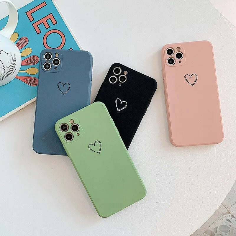 Solid colour silicone TPU back cover case for Apple iPhone on a table, showing colour options.