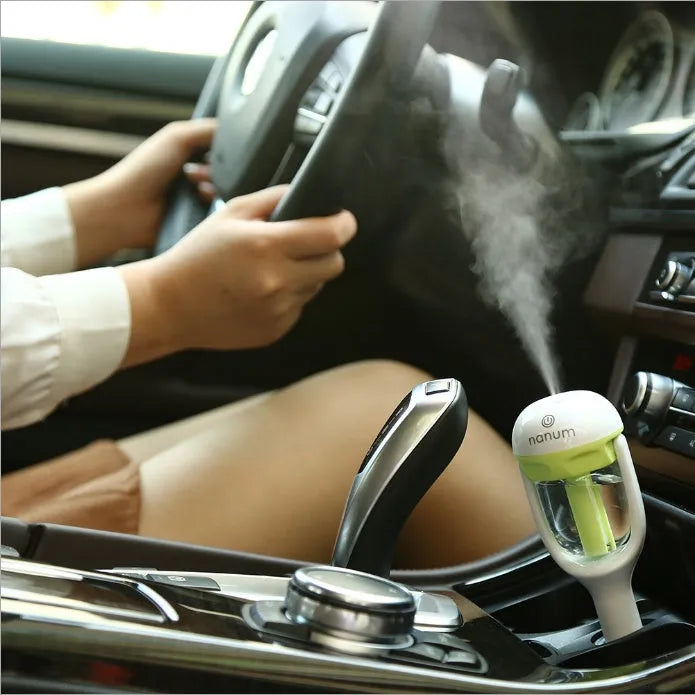 Compact blue car humidifier with essential oil diffuser function on car dashboard