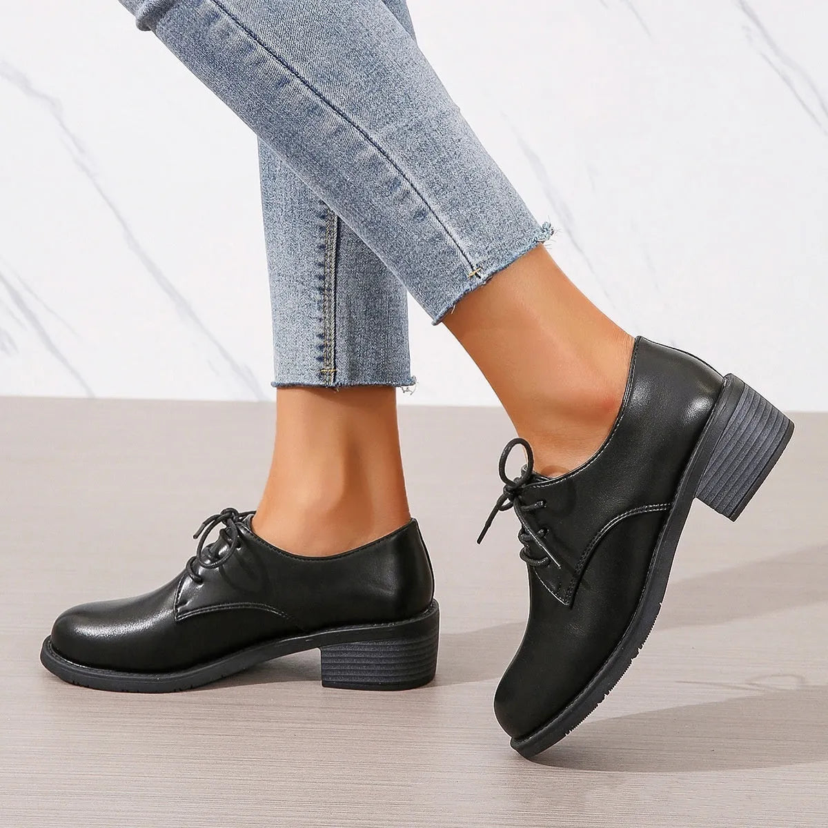 Black women's low top work shoes with a short chunky heel and pointed toe.