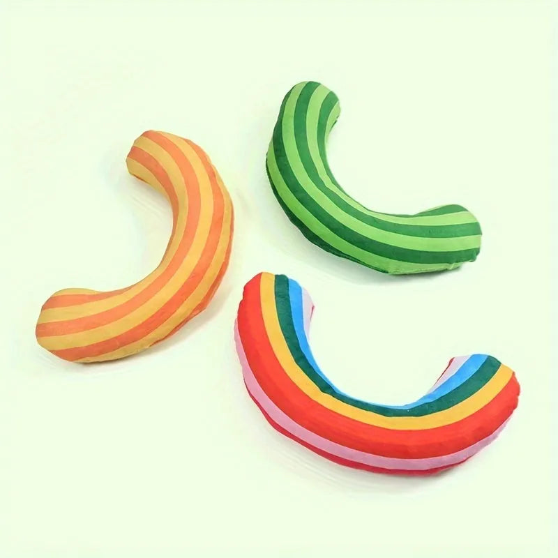 Green, rainbow, and yellow striped plush cat pillow with attached noise toy, measuring 23cm by 20cm.