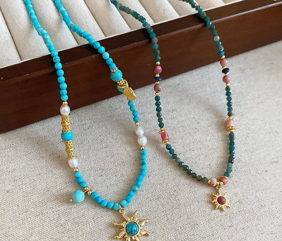 Freshwater pearl necklace with stone sun pendant, French court style, blue and golden-blue-pink colours