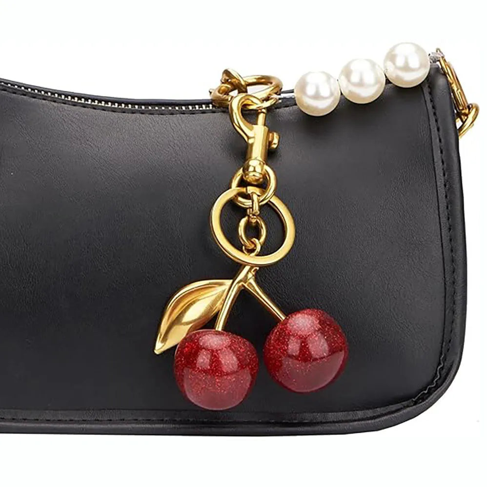 Three-dimensional cherry-shaped zinc alloy key ring pendant in pink or red colour.
