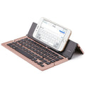 F18 three-fold folding aluminium alloy Bluetooth keyboard in golden, expanded view showing 58 keys