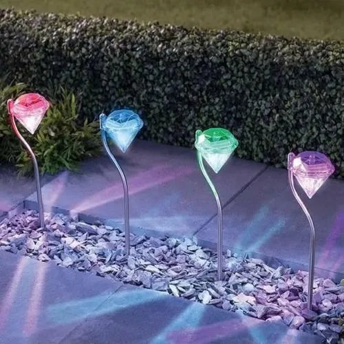 Solar powered garden diamond light with adjustable angle and solar panel on adjustable mount.