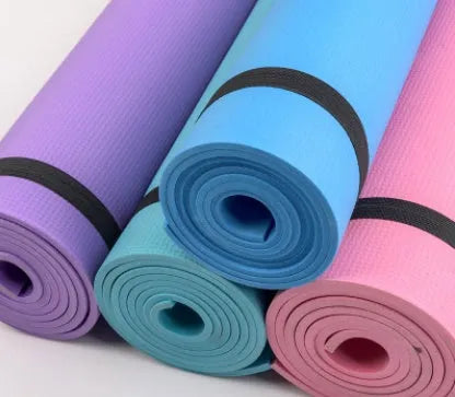 EVA foam yoga mat in blue, showing textured anti-slip surface, with a black OPP storage bag beside it.