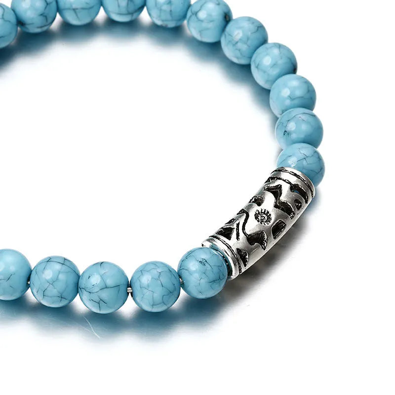 Classic acrylic blue beaded bracelet on wrist showing stretchy cord and smooth round beads