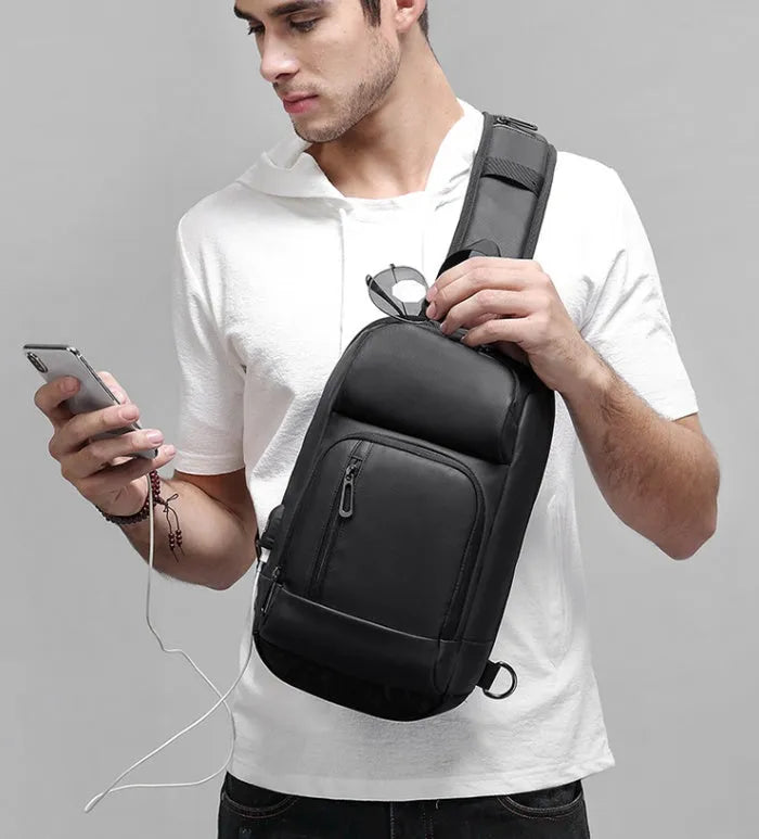 Black PVC outdoor leisure shoulder bag with air cushion strap and internal organisers