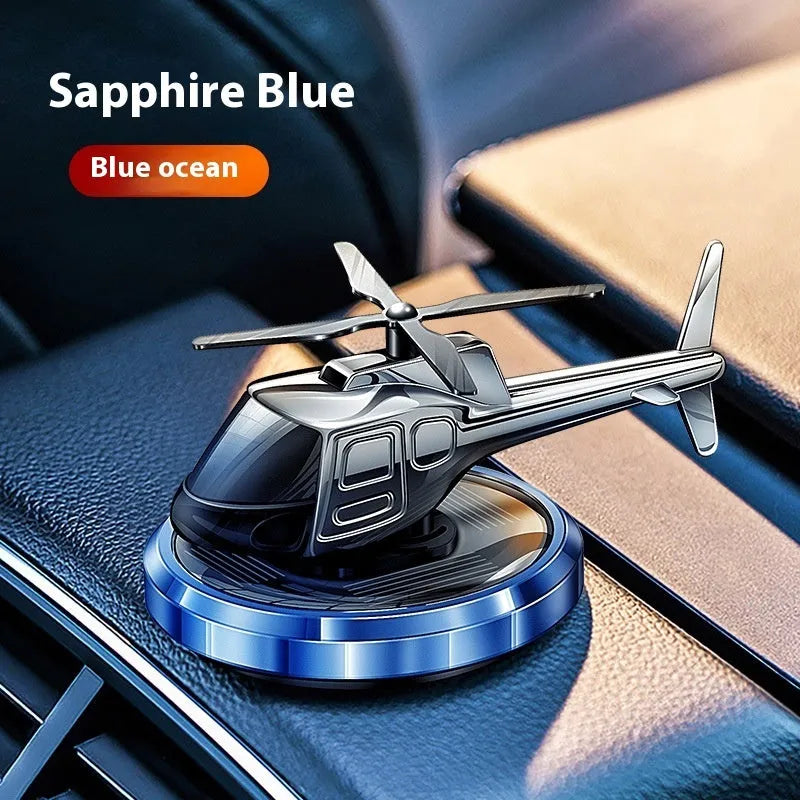 Silver metal solar helicopter car perfume ornament with rotating blades on dashboard