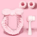 Facial brush set with coral fleece hair band and four nylon brush heads in purple grey white pink colours