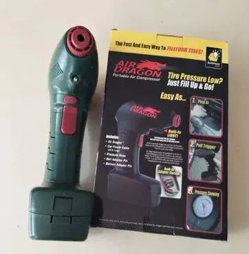 Portable 12V car tyre electric pump with digital gauge and hose on a grey background.