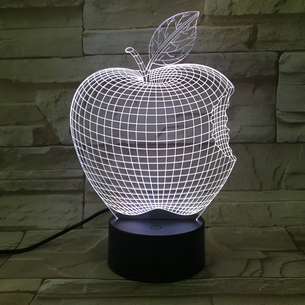 Colourful 3D fruit shaped acrylic LED night light with touch control on a table.
