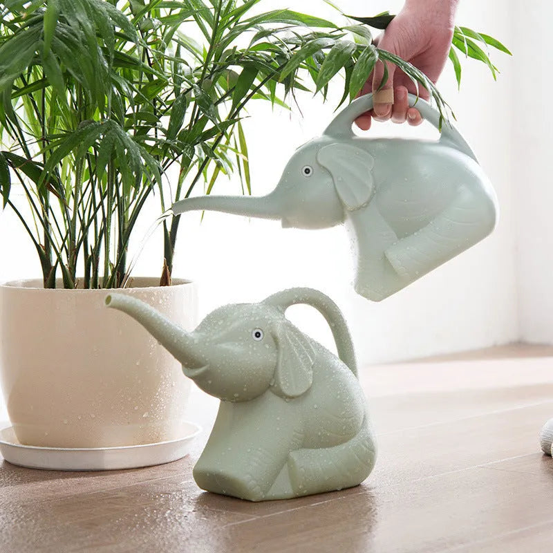Pink children's watering can shaped like a sitting baby elephant with a long spout.