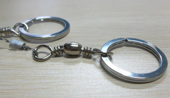 Stainless steel wire survival saw with thumb rings coiled for outdoor camping