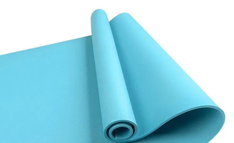 EVA foam yoga mat in blue, showing textured anti-slip surface, with a black OPP storage bag beside it.
