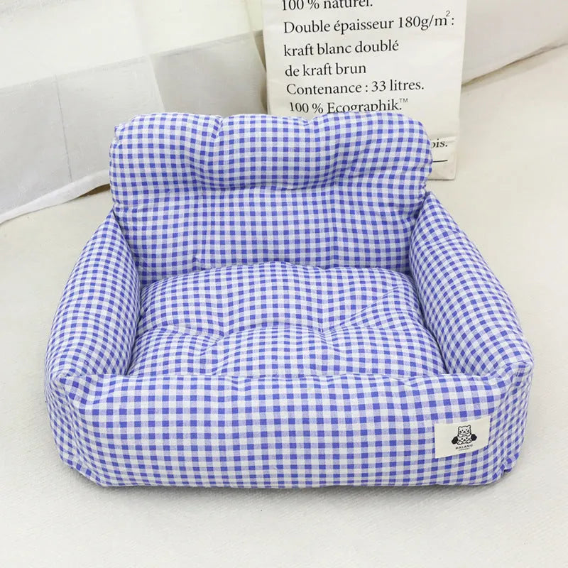 Car-mounted pet outing nest in grey and blue plaid options showing stain-resistant cloth construction