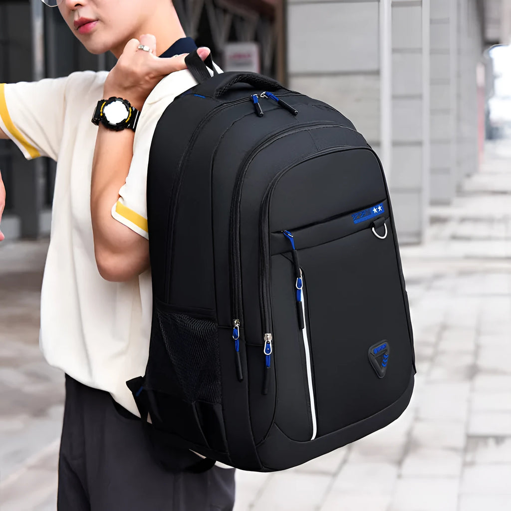 Men's Oxford cloth schoolbag with letter pattern in black, blue, green, or red colours showing air pillow belt system