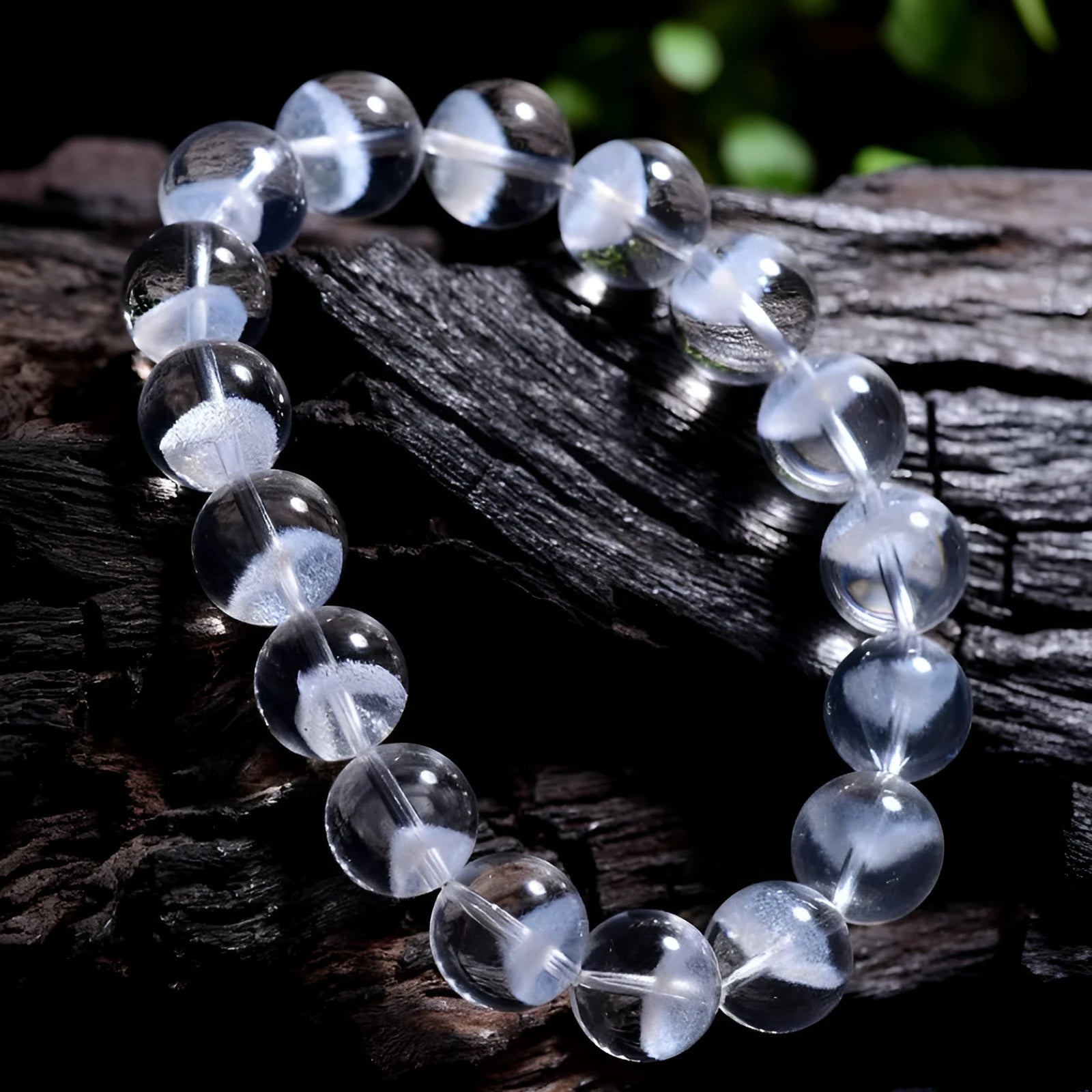 Women's white crystal ghost pyramid bracelet with ruyi charm on a wrist, showing bead detail.