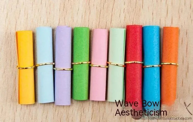 Assorted coloured mini paper scrolls for drift bottle messages with metal eyelets, shown in different sizes.