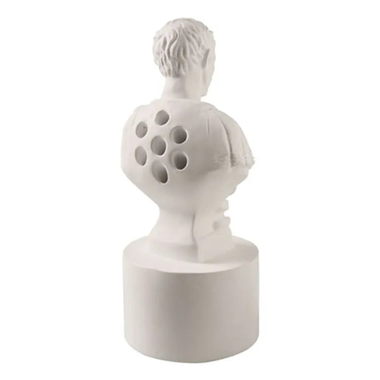 White synthetic resin character model pen holder on a desk.