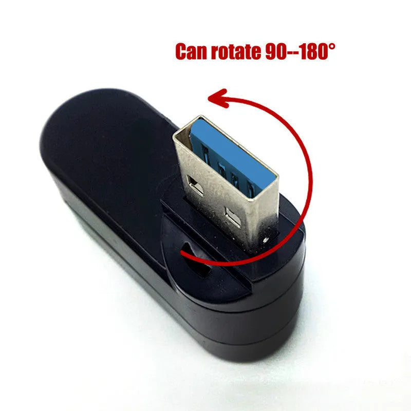 Black or white 4-port USB hub on a desktop next to a laptop and various peripherals.