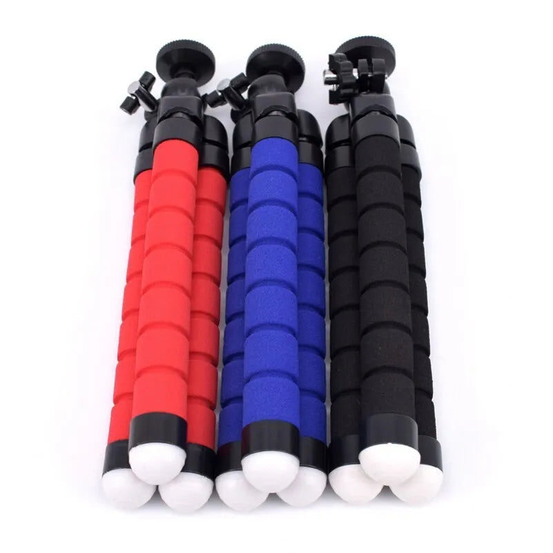 Black flexible octopus tripod with bendable legs wrapped around a pole, holding a smartphone.