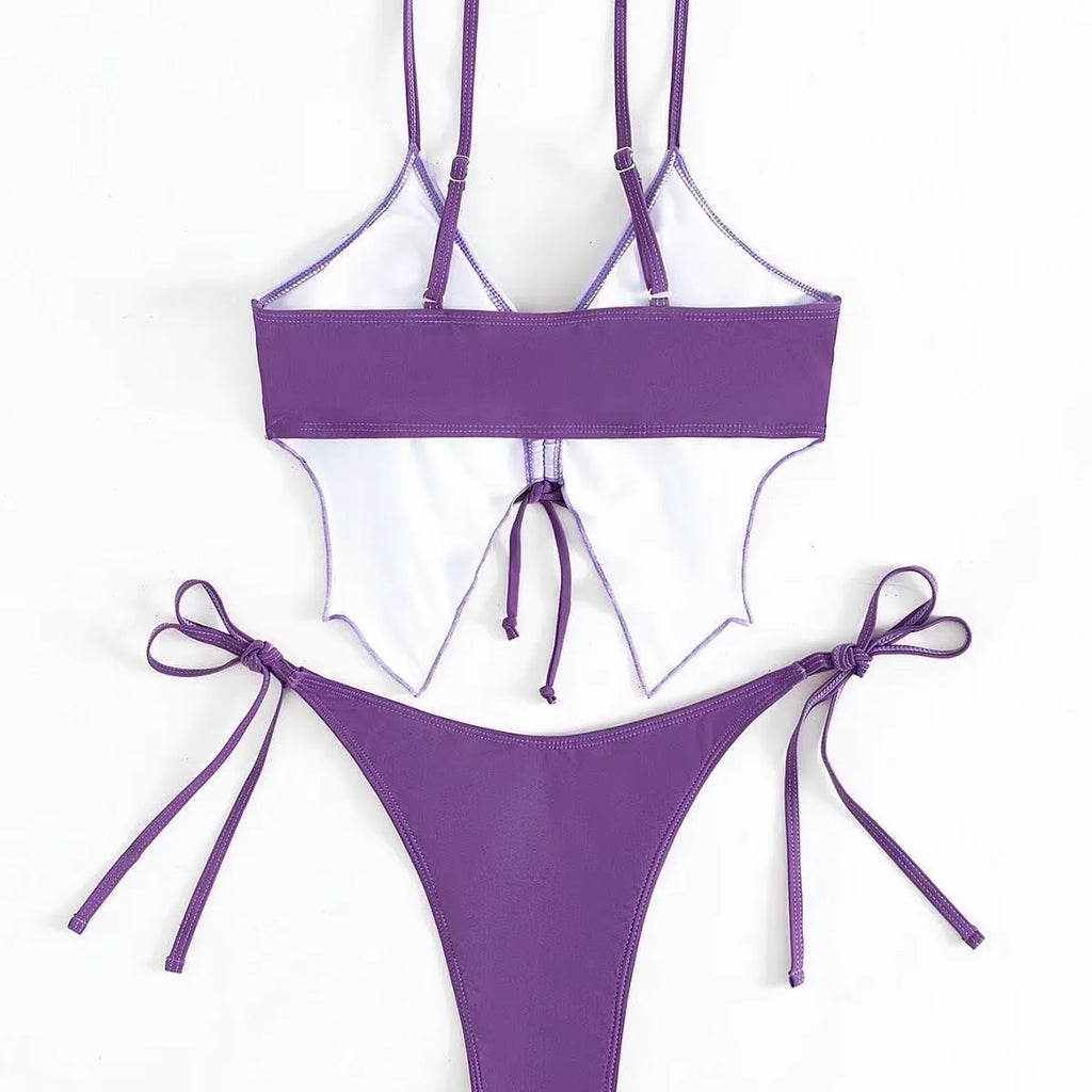 Women's purple bikini swimsuit with bow detail and split-style briefs on a mannequin.
