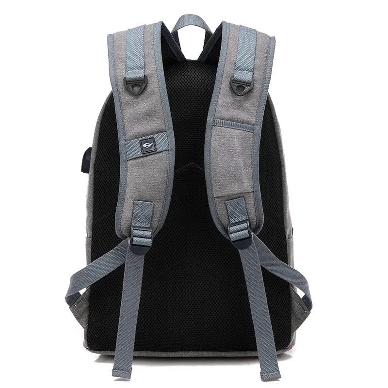 Coffee coloured canvas backpack with USB charging port and multiple zippered compartments