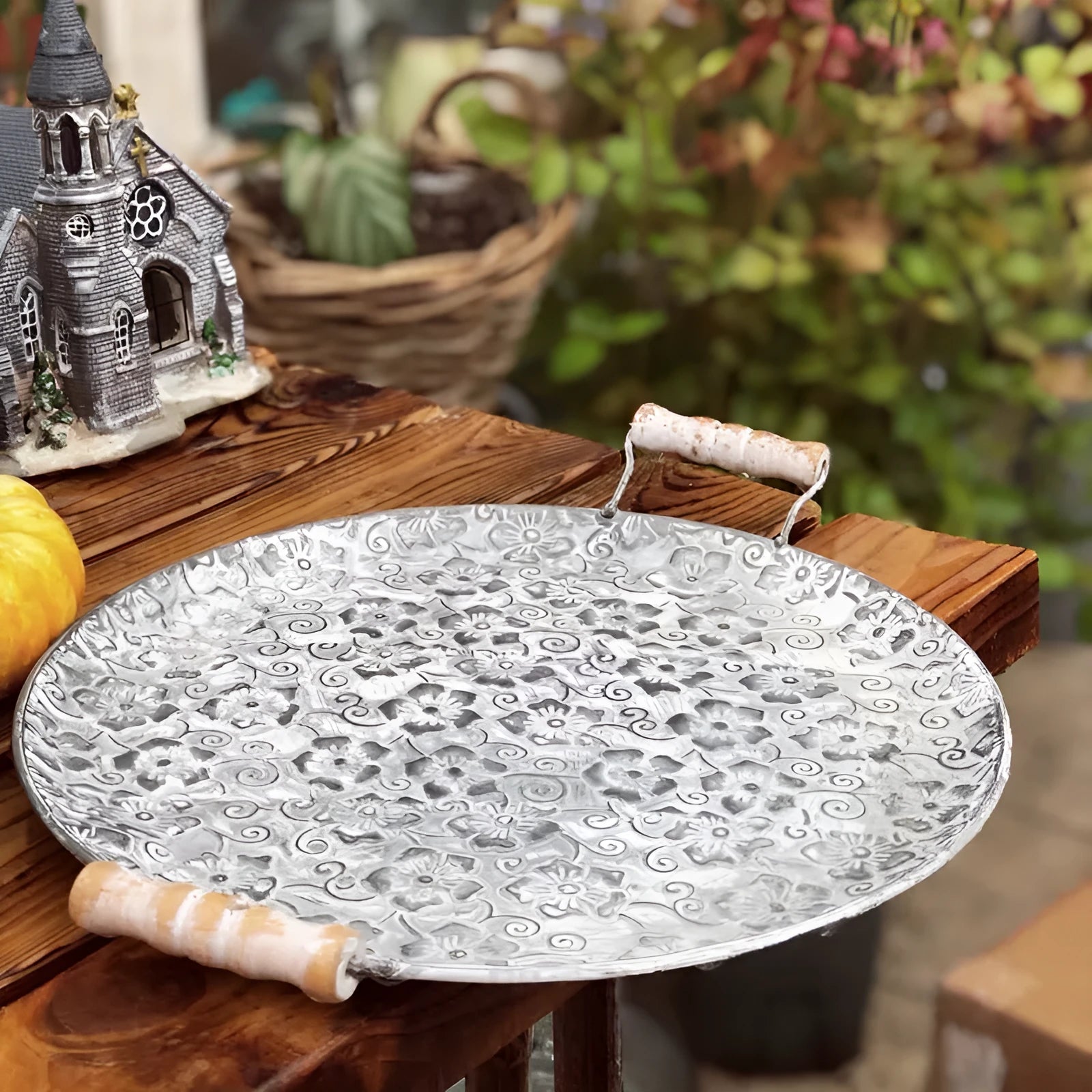 Round wrought iron storage tray in two sizes on a wooden table.