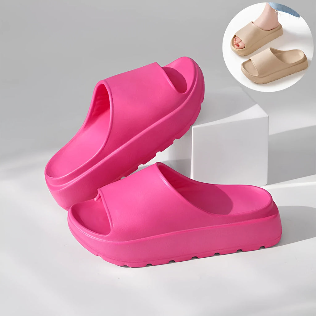 Women's beige fish mouth slippers with a thick sole on a wooden floor.