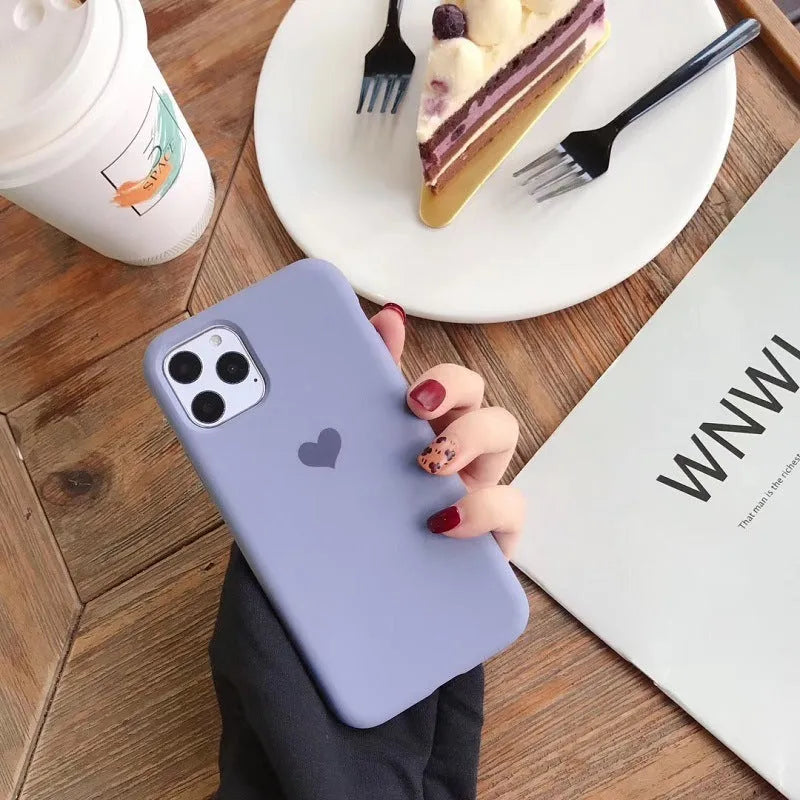 Solid colour silicone phone case for iPhone models showing dark green, light pink and purple options