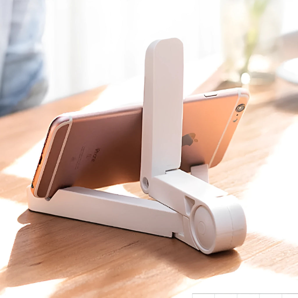 Black foldable tablet holder open in landscape mode holding a smartphone, showing its compact size and non-slip rubber surface.