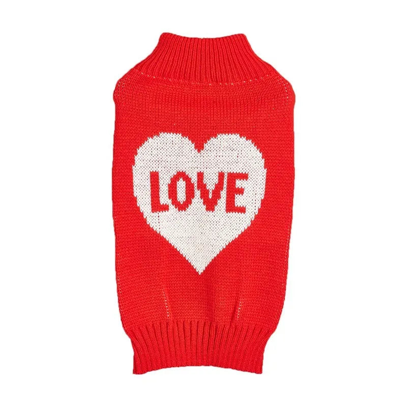 Small dog wearing an acrylic sweater with pink bow and love heart design