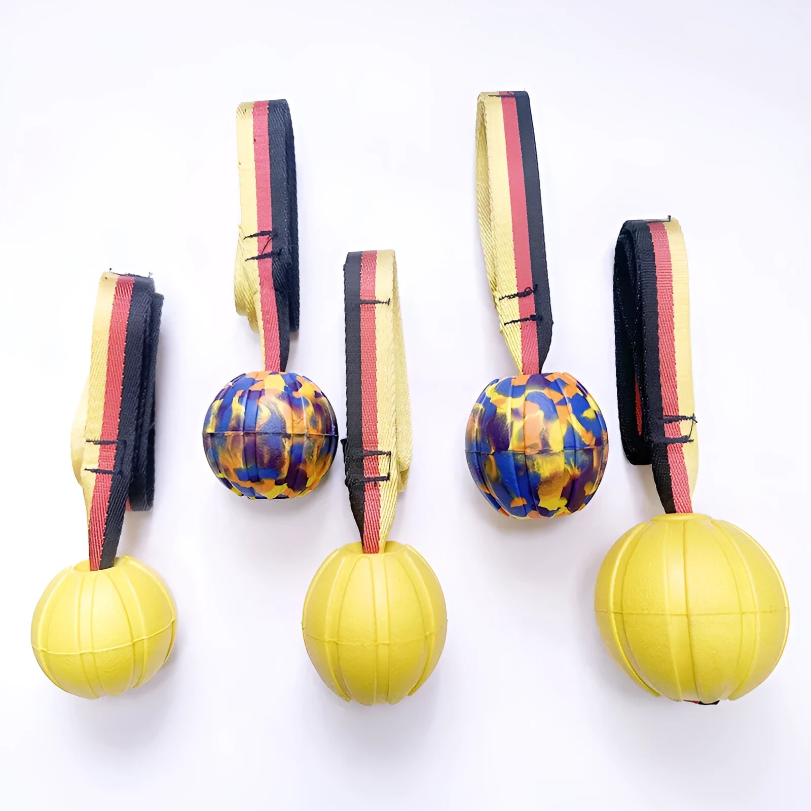 Yellow and camouflage coloured EVA foam floating tetherball dog toys in three different sizes on a blue background.