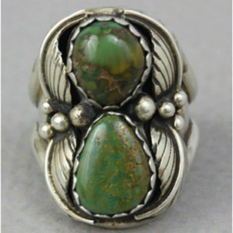 Close-up of a turquoise geometric women's alloy ring on a hand, showing its angular shape and metallic finish.