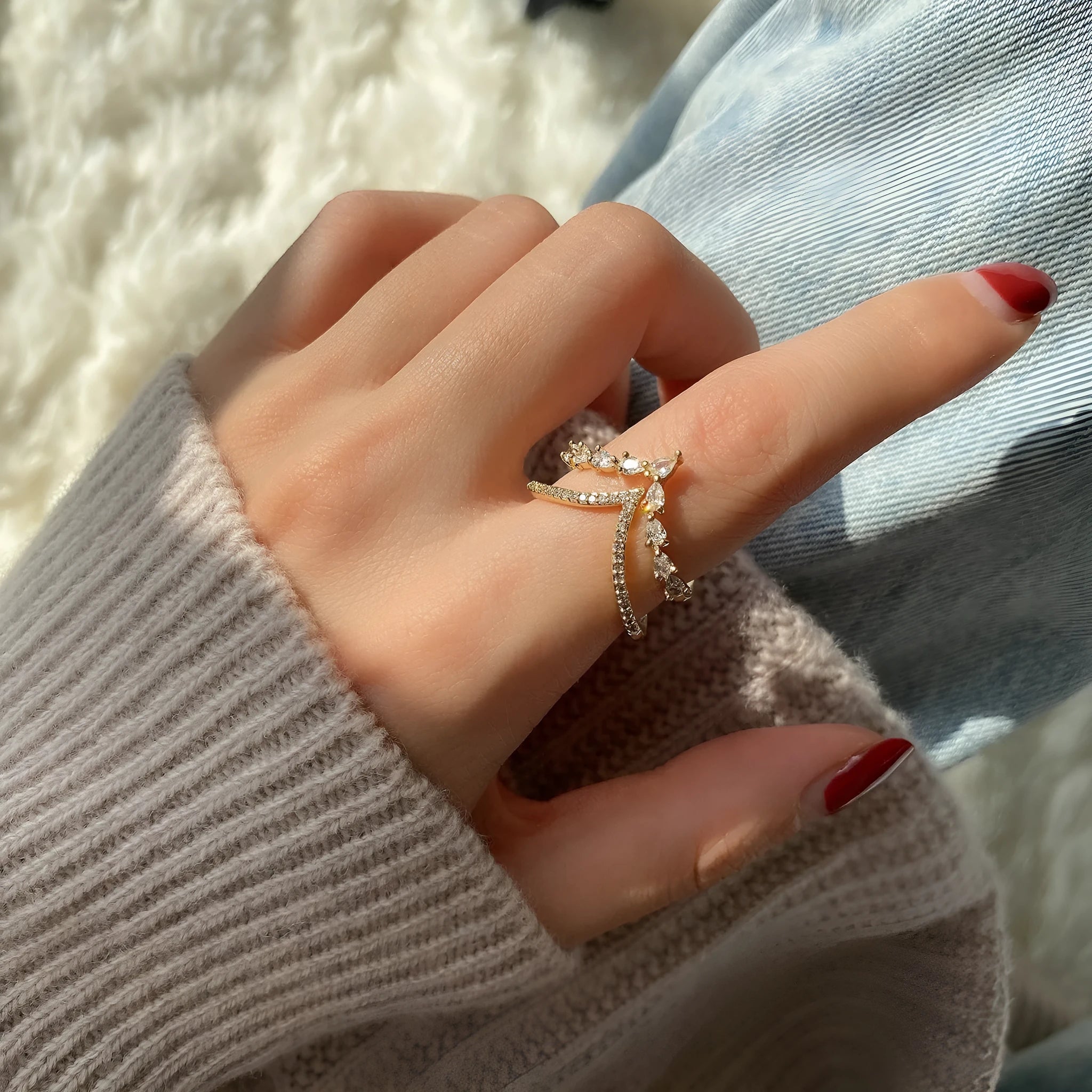 Gold plated copper heart shaped ring with full diamond detailing on white background