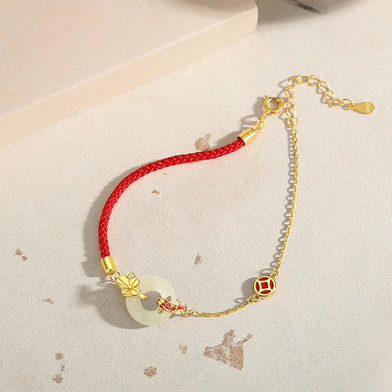 Gold electroplated 925 sterling silver bracelet with red rope and peace buckle featuring koi fish design