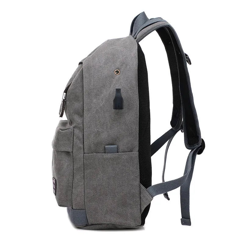 Coffee coloured canvas backpack with USB charging port and multiple zippered compartments