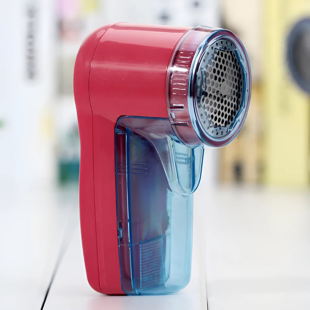 Portable electric clothing lint remover device on a sweater.