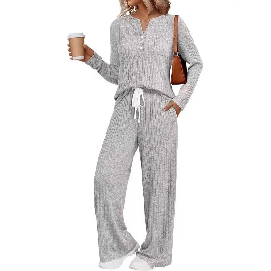 Knitted V-neck striped long coat with long sleeves, pockets, and a lace-up detail on a hanger.